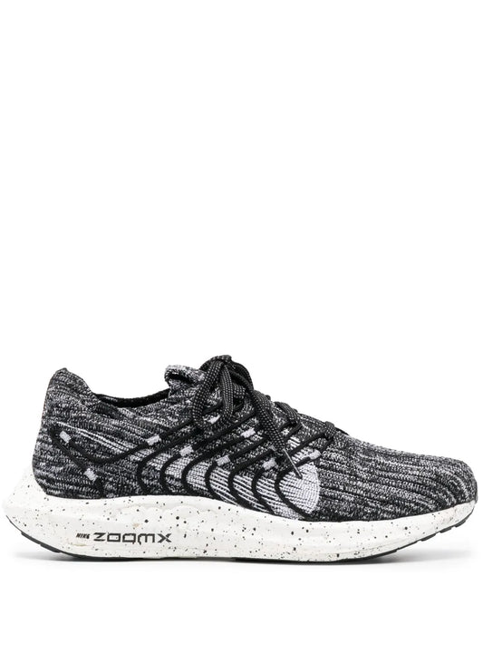 Black and gray knit running shoe with lace-up, Nike swoosh, white speckled midsole