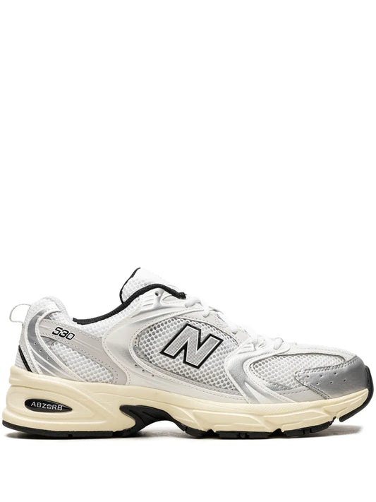White low-top sneaker with N logo, mesh panels, cream midsole and black accents.
