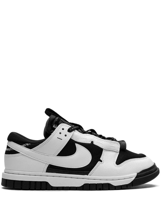 Black and white low-top sneakers with Nike Swoosh and lace-up closure