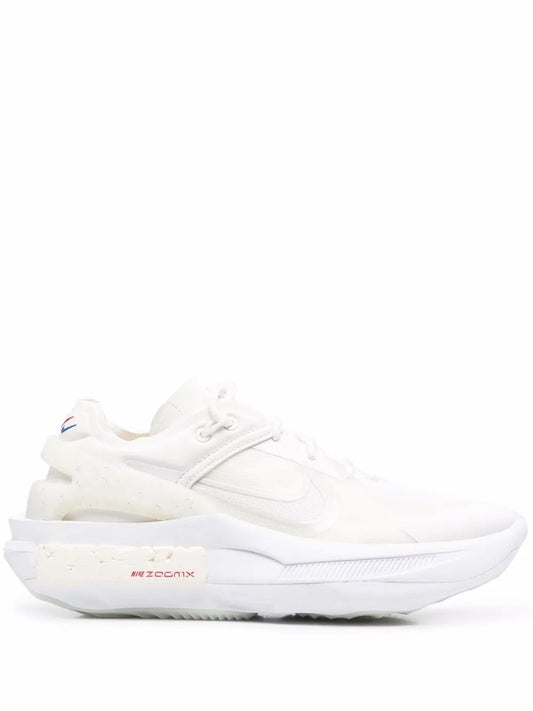 White Nike low-top sneaker with lace-up closure and side swoosh logo