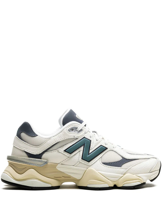 White lace-up New Balance 9060 sneakers with teal N logo patch and chunky sole