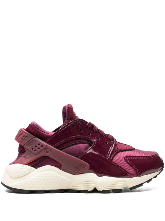 Nike Air Huarache sneakers in burgundy with white sole and lace-up upper