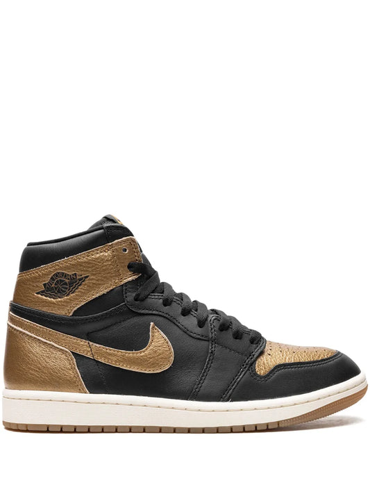 Nike Air Jordan 1 trainers in black and tan with gold Swoosh and wing logo