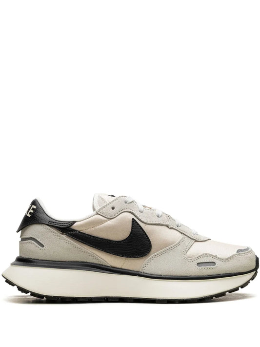 Beige and black Nike sneakers with waffle sole, side view