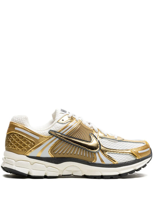 Nike Zoom Vomero 5 running shoe in white, gold and black; chunky cushioned sole