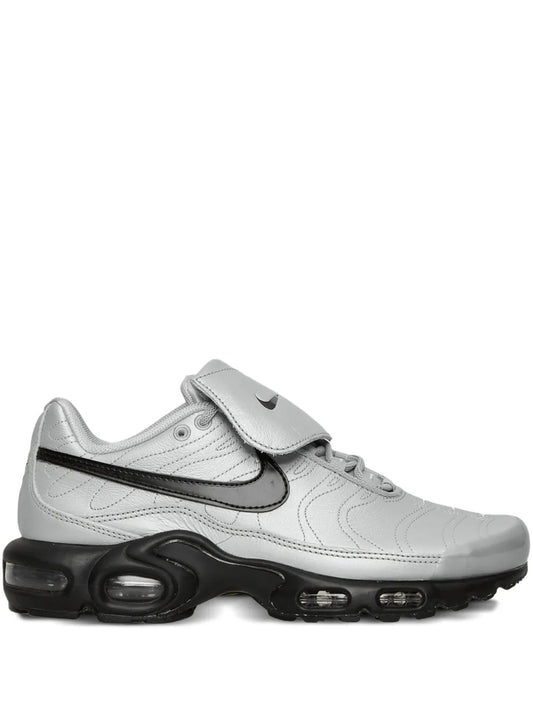 Nike Air Max Plus sneakers, light gray upper, black swoosh, visible air sole