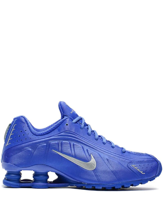 Nike Shox R4 blue sneakers, laced side view with Swoosh and springy pods