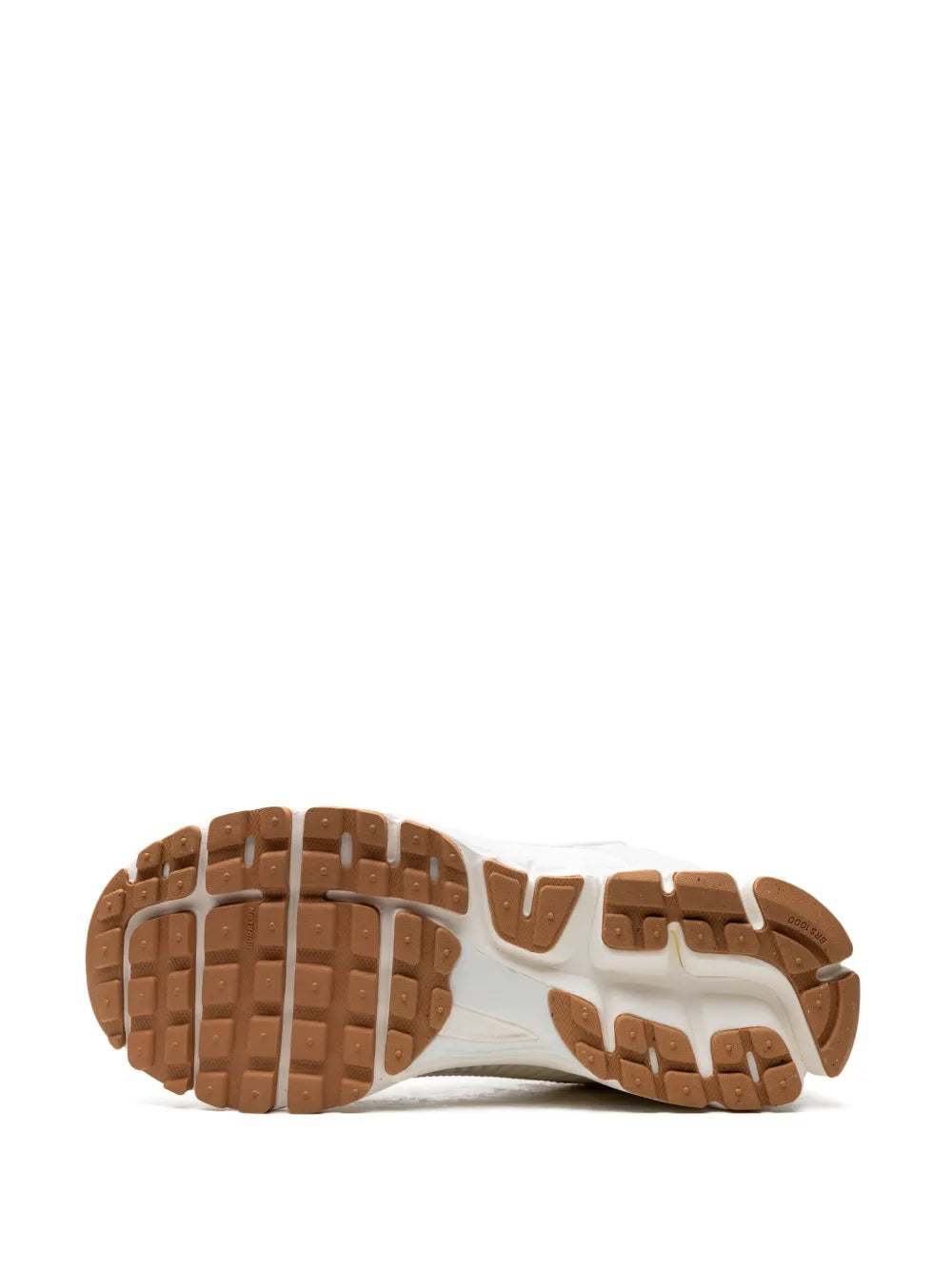 White Nike running sneakers outsole view with brown rubber tread and white midsole