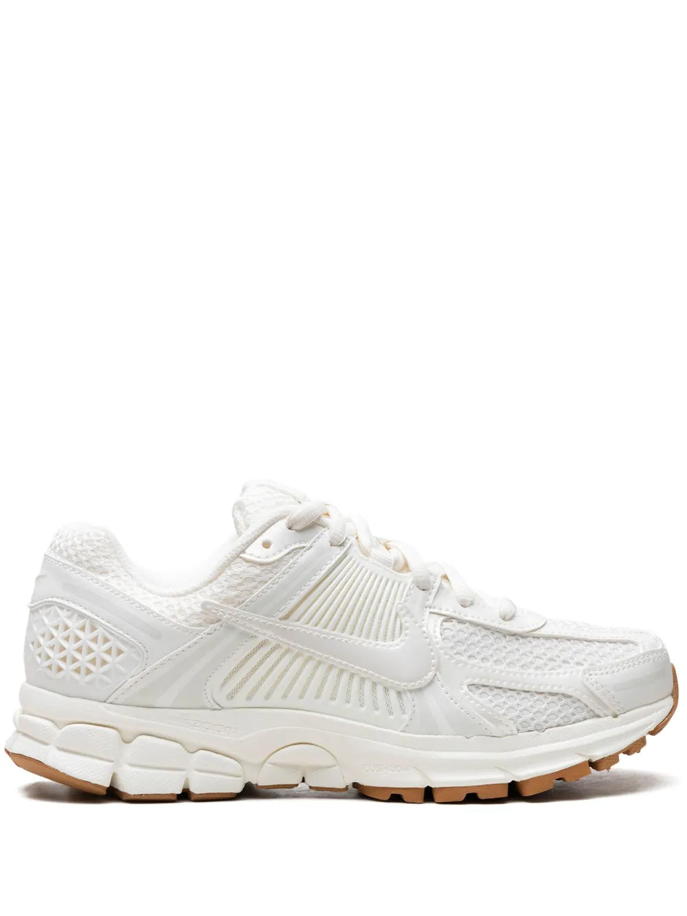 White Nike running sneakers, lace-up with swoosh logo, textured mesh upper, cushioned sole