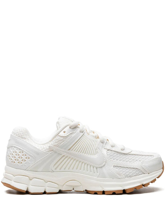 White Nike running sneakers, lace-up with swoosh logo, textured mesh upper, cushioned sole