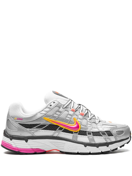 Nike P-6000 sneakers in white with gray panels, yellow-orange swoosh, pink outsole