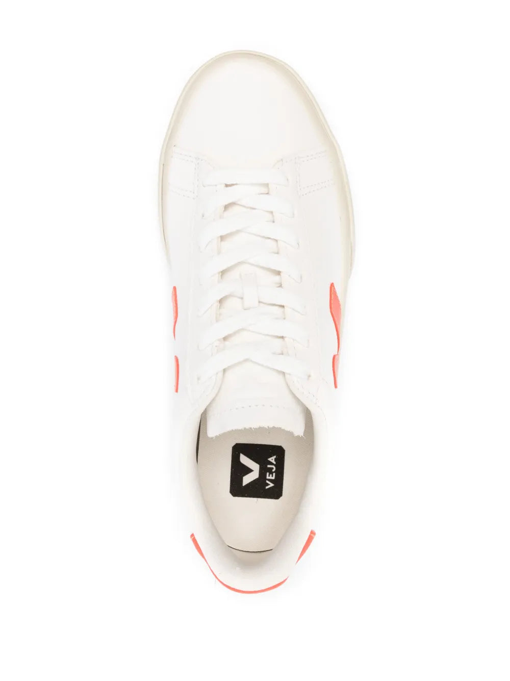 White low-top sneakers, top view with orange trim near eyelets and black tongue label