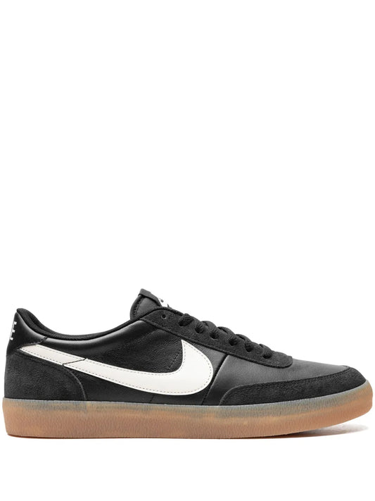 Black leather sneakers with white swoosh and gum rubber sole