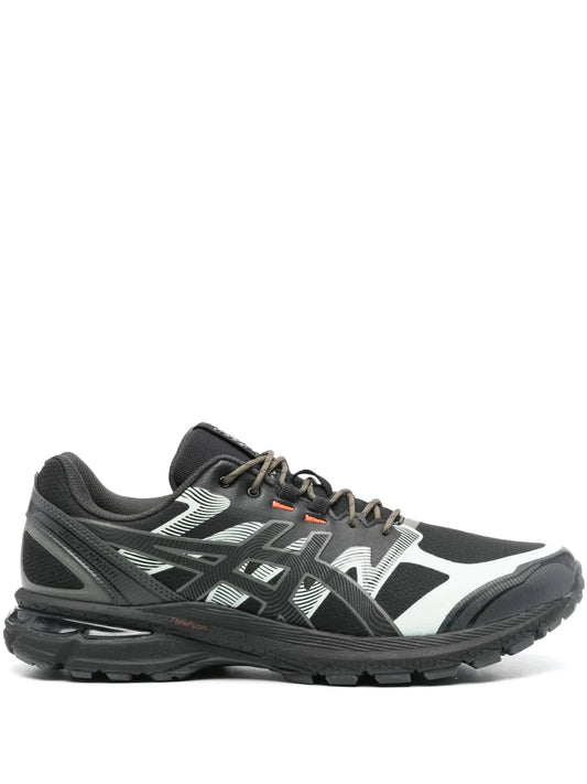 ASICS Gel-Terrain trail running shoes in black, gray, and white with orange accents