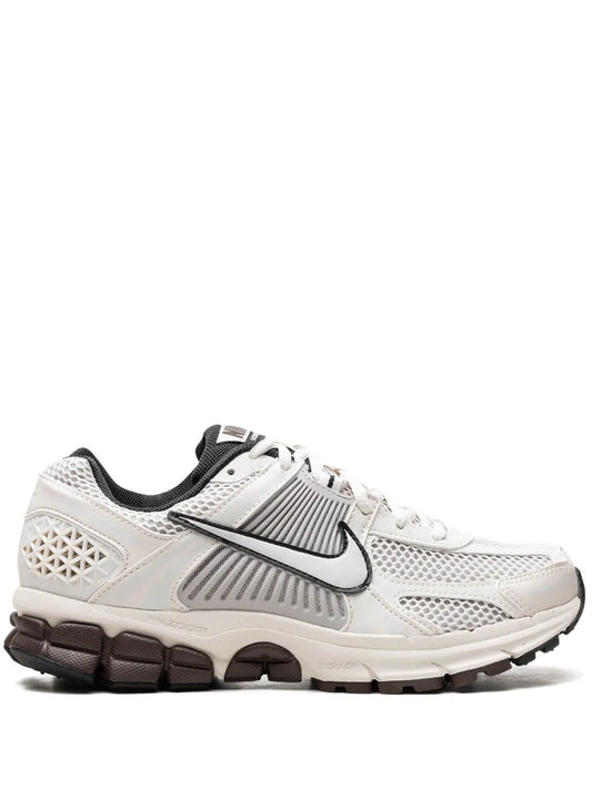 Nike white Air Zoom sneaker with black swoosh and mesh upper, lace-up.