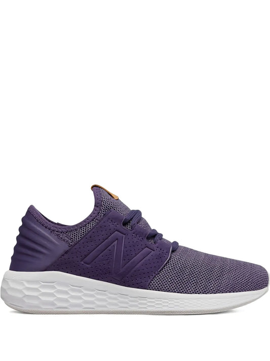 Purple lace-up running shoe with knit upper, New Balance logo, and white foam sole