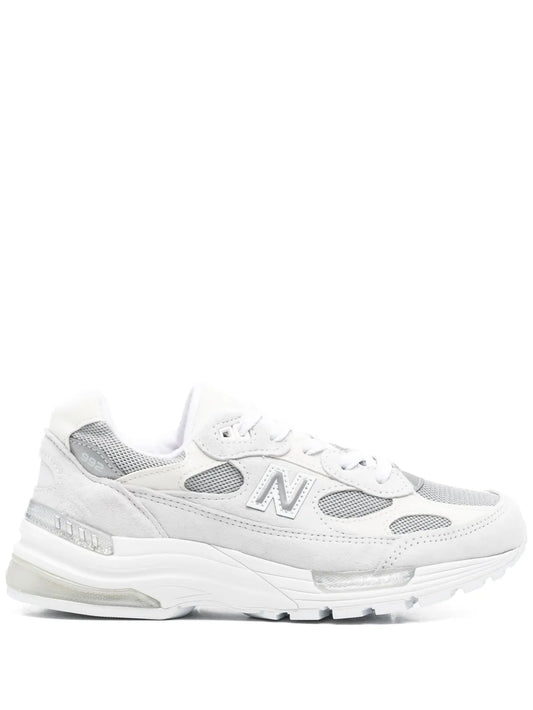 Light grey and white lace-up running sneakers with "N" logo and padded collar