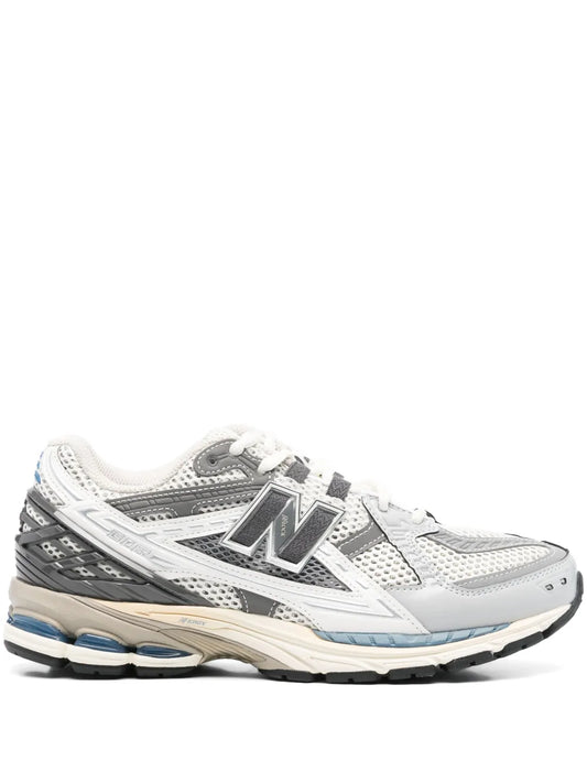 Grey lace-up running sneaker with N logo, layered panels, and black rubber sole