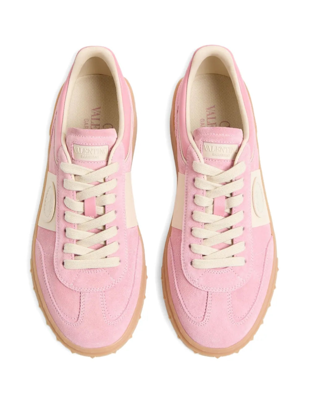 Pair of pink lace-up sneakers with off-white laces and tan rubber sole