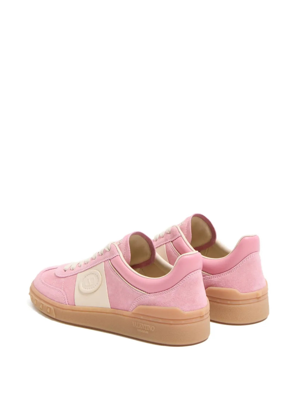 Pink lace-up sneakers showing side and heel with tan rubber sole