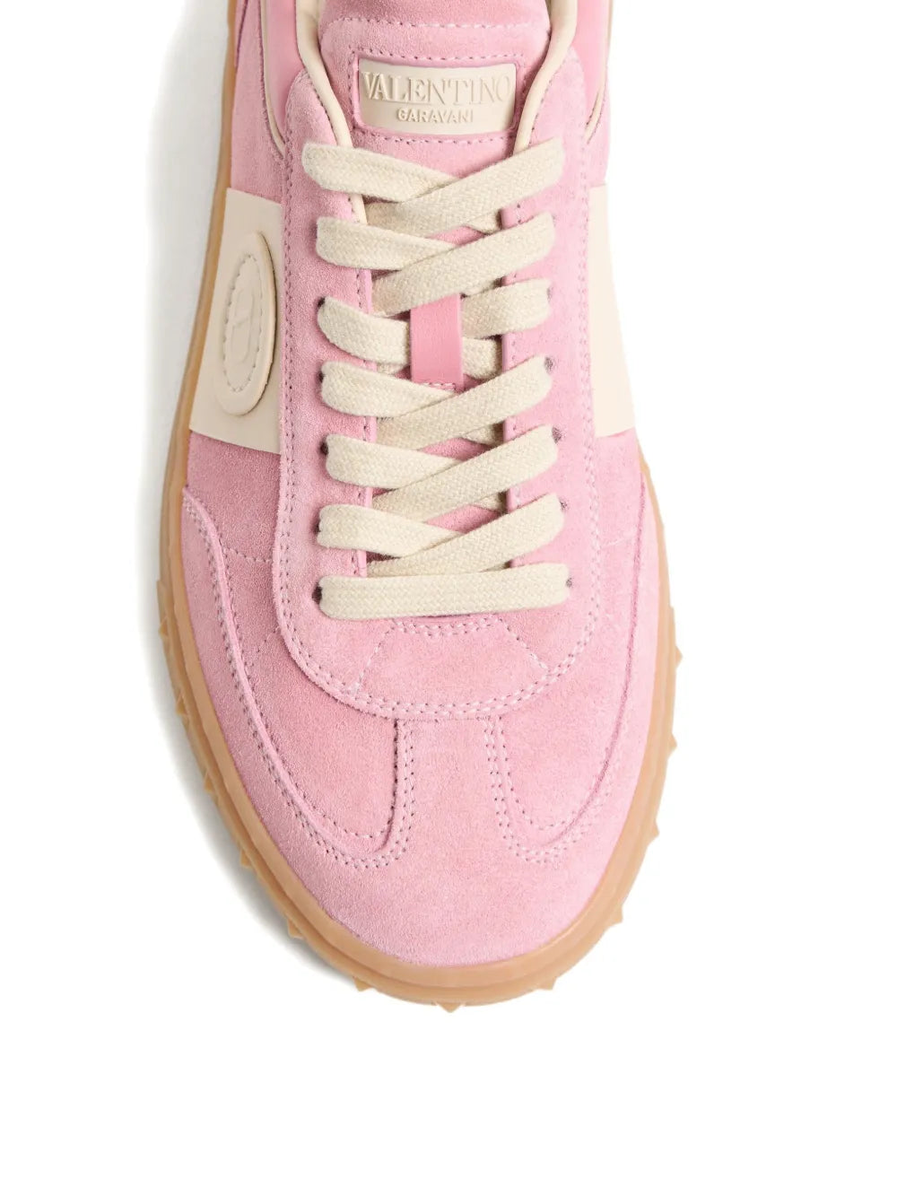 Pink suede sneakers with lace-up front and beige logo patch detail