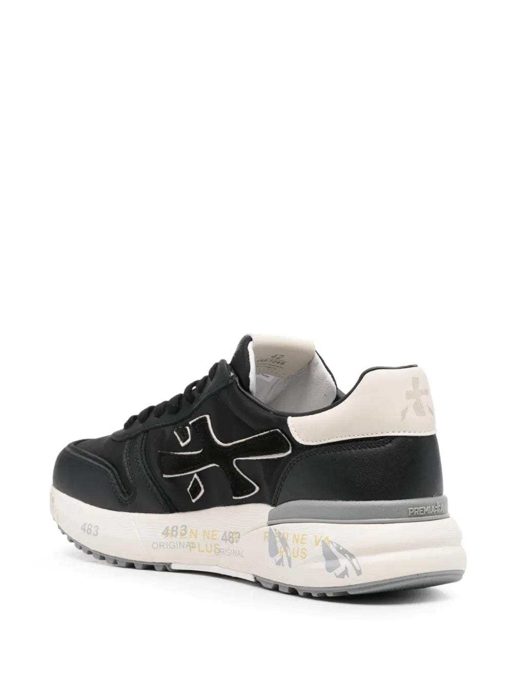 Black low-top trainers with white heel panel and lace-up, cushioned rubber sole