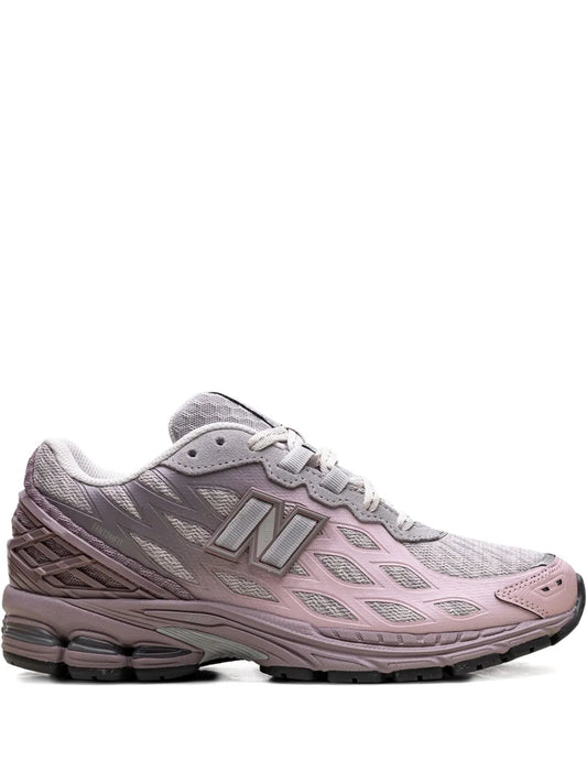 Light gray lace-up sneaker with pink accents and cushioned sole, N logo.