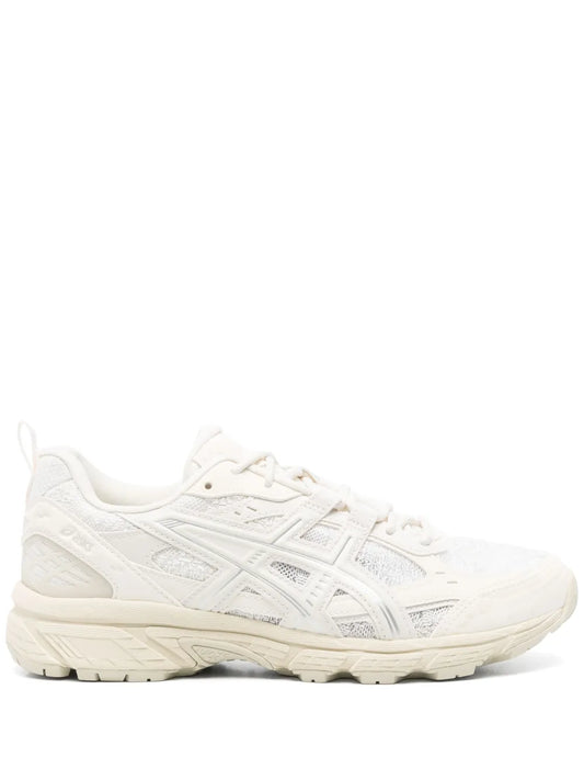White lace-up athletic sneaker with logo accents and thick cushioned sole