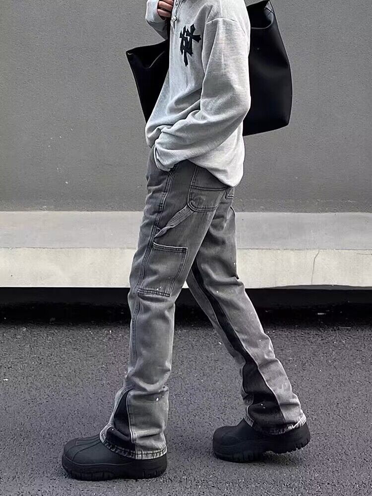 Gray distressed denim jeans with loose straight legs, visible stitching and pockets