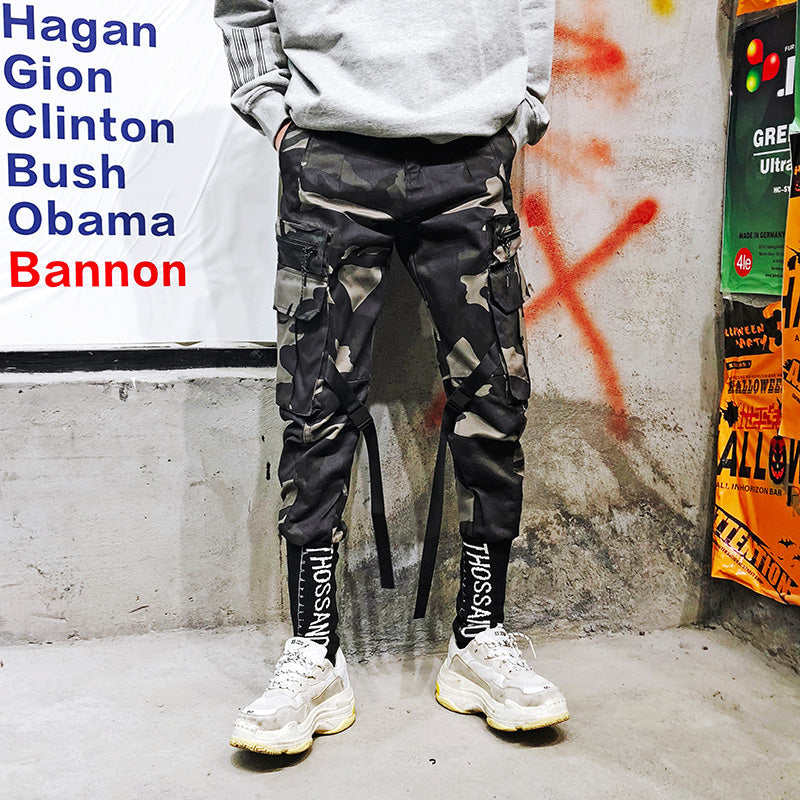 Black cargo pants with cinched waist drawstring, cargo pockets, straight legs.
