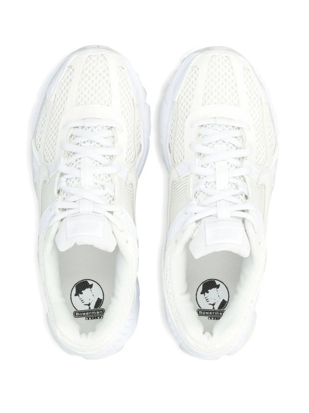 Pair of white Nike lace-up sneakers with mesh uppers and cushioned rubber toe guards