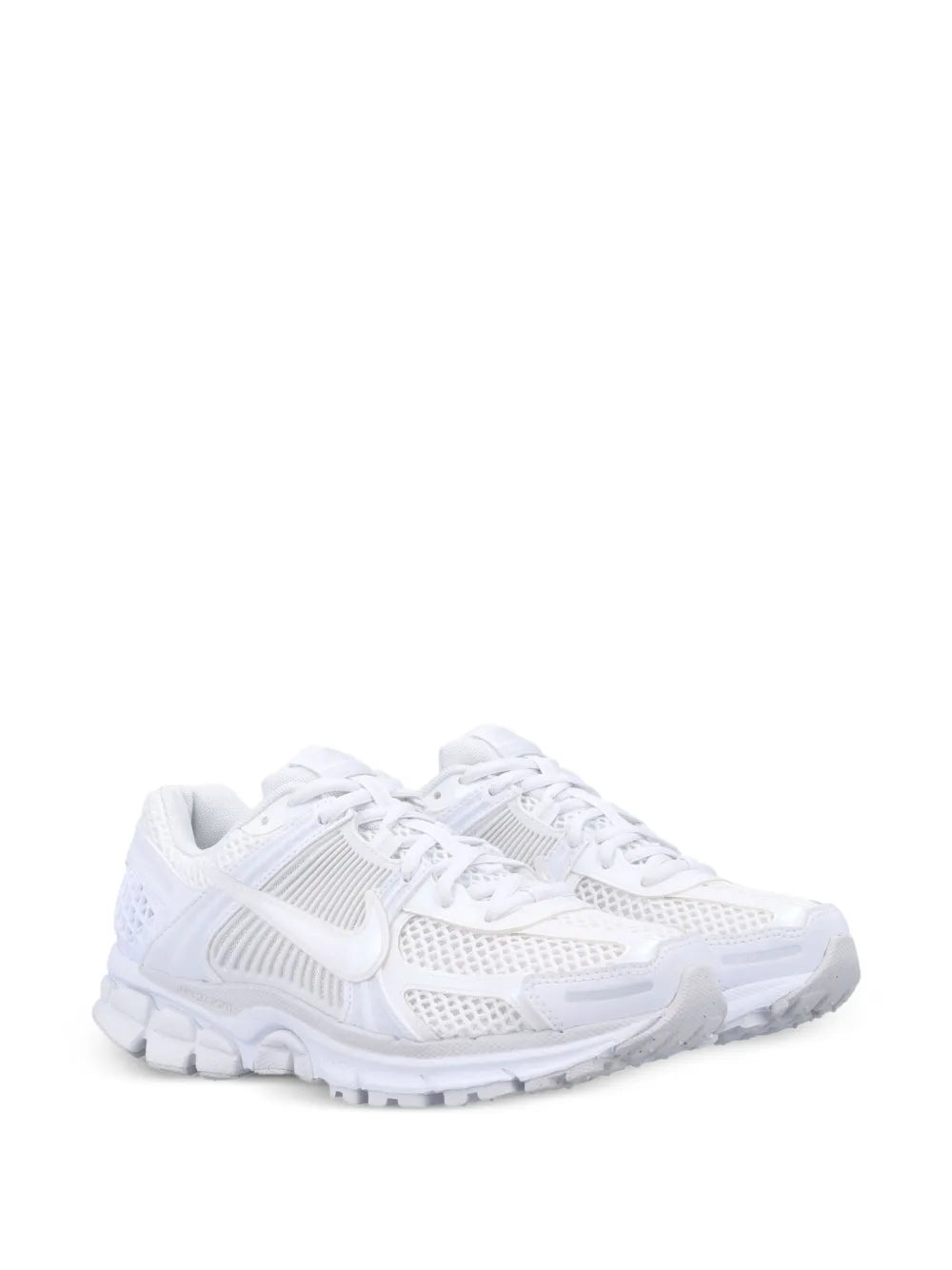 White Nike running sneakers, mesh upper, visible Swoosh, chunky cushioned midsole