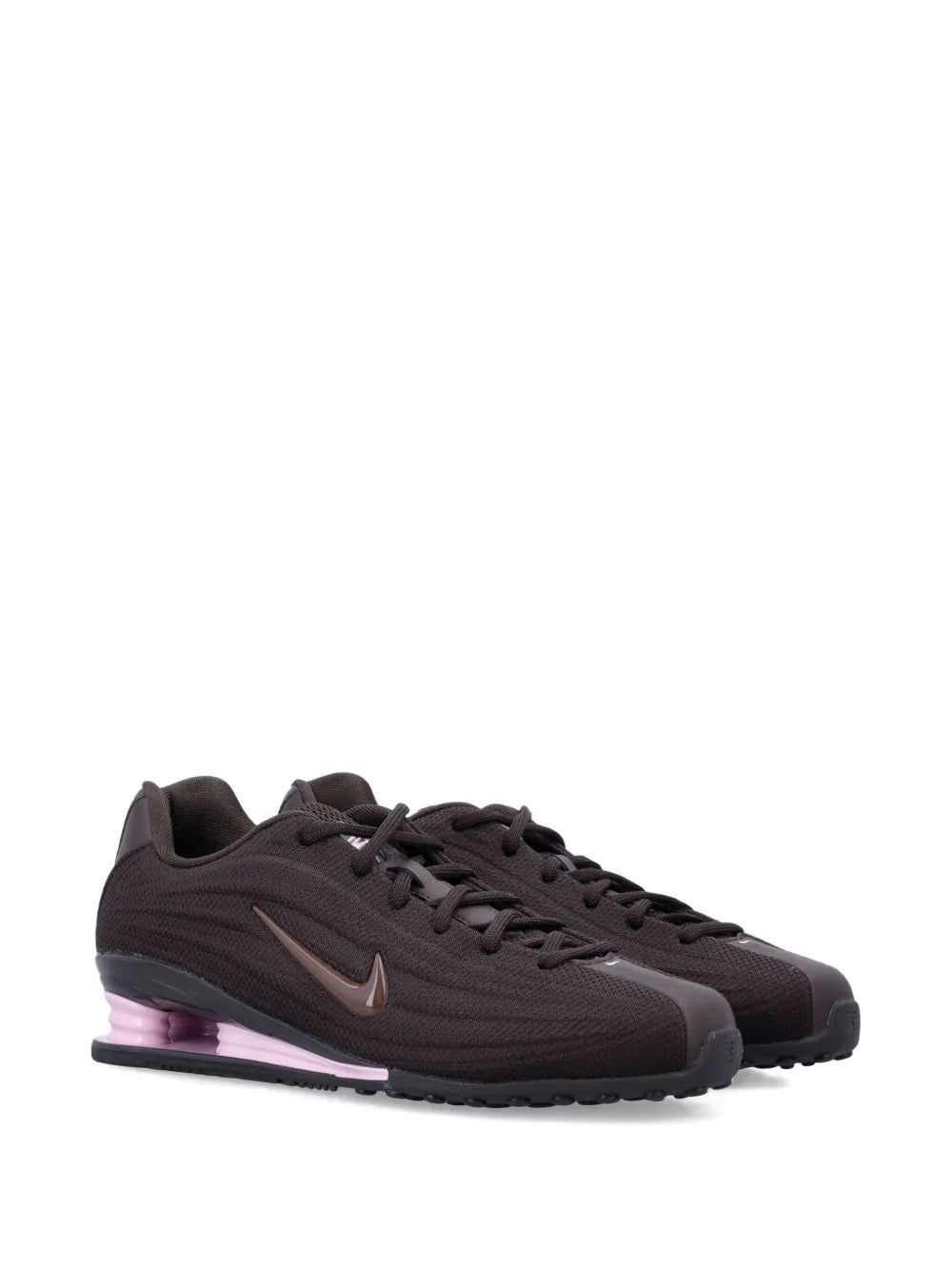 Dark brown Nike trainers, side view with Swoosh and purple-tinted midsole