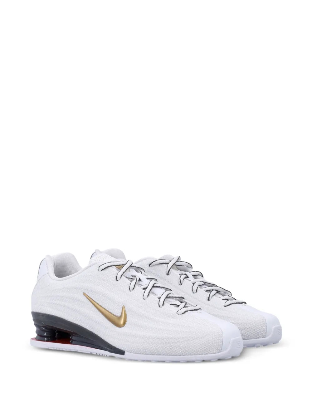 White lace-up trainers with gold swoosh, side profile and dark heel air unit