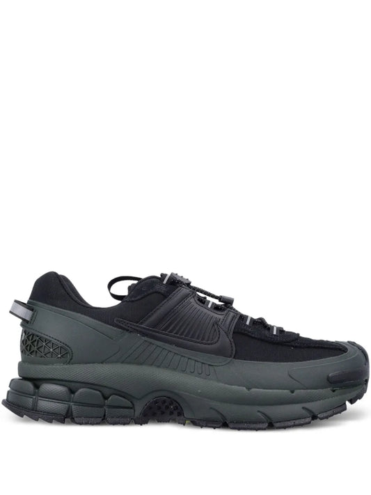 Nike Zoom Vomero trainers in black with dark green midsole and chunky rubber outsole