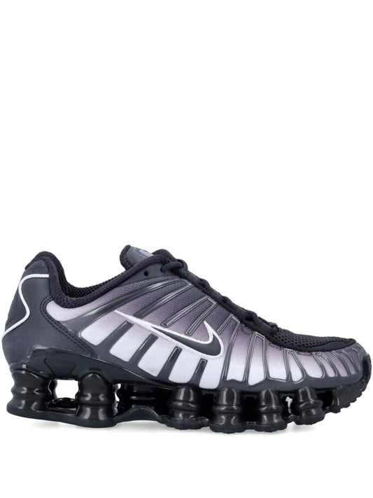 Black lace-up trainers with silver Swoosh stripes and chunky pod sole