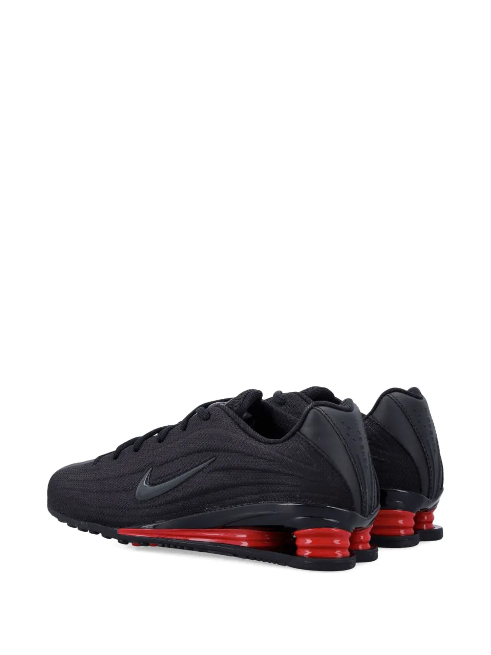 Black Nike Shox Z trainers with lace-up design and red heel cushioning