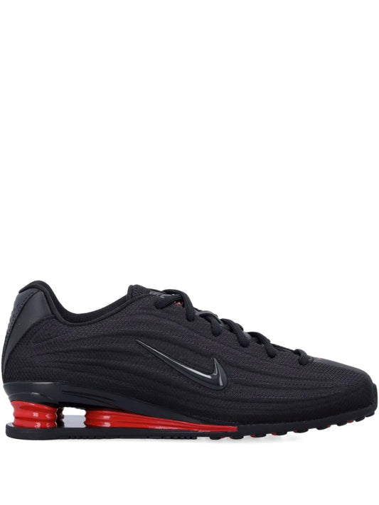Black Nike Shox Z trainers with Nike Swoosh and red cushioning pods