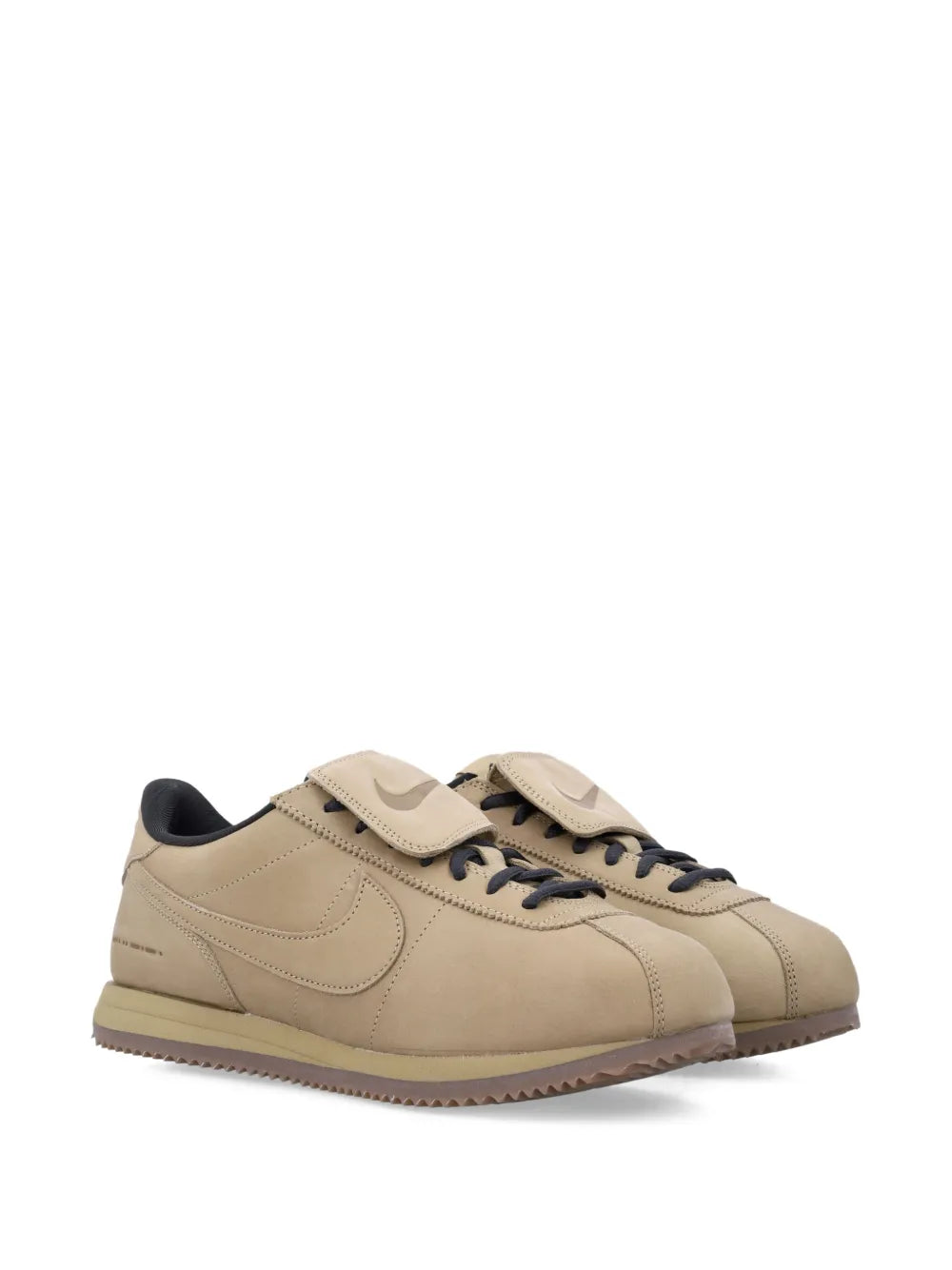 Nike beige leather lace-up sneaker with swoosh and strap, gum sole