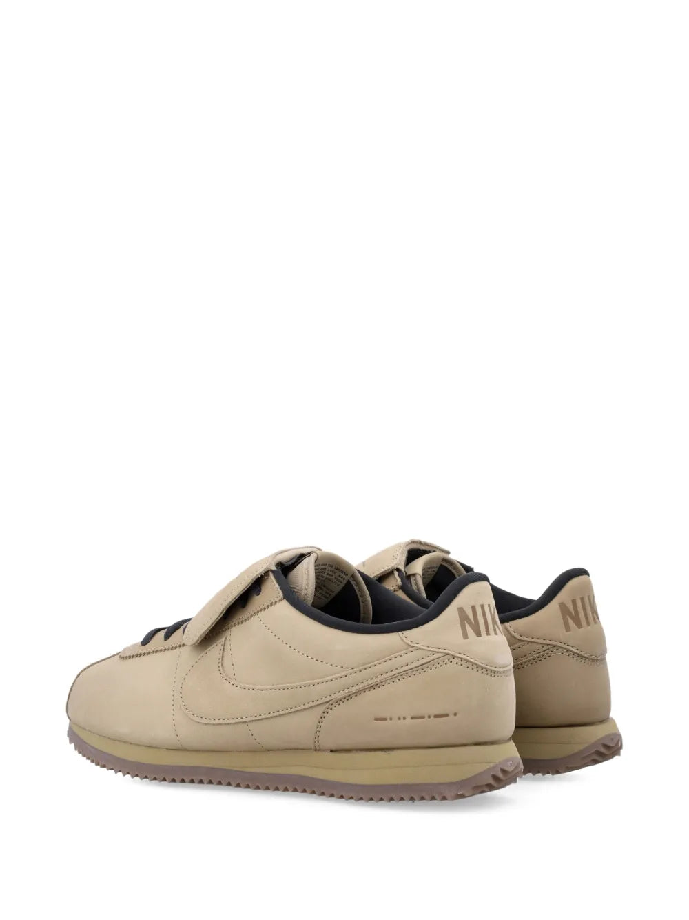 Nike beige leather lace-up sneaker heel view, black lining and gum sole