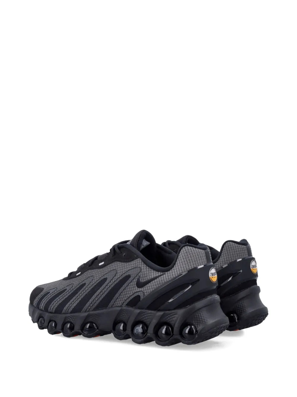 Nike black panelled lace-up trainers, rear side view with round tread pods