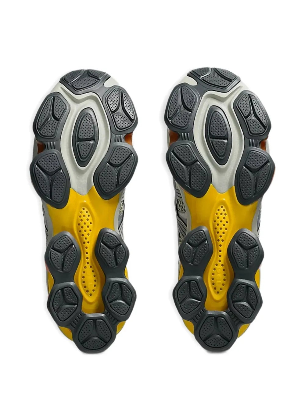 Pair of grey outsoles with yellow and orange traction pods