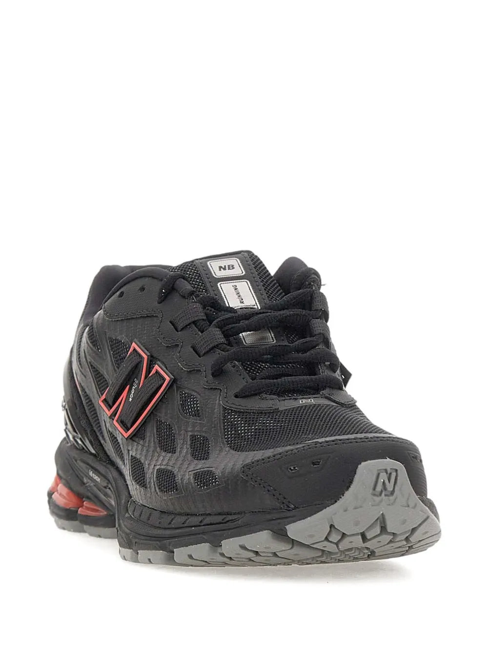 Black athletic sneaker with NB logo, padded collar, and red heel accent