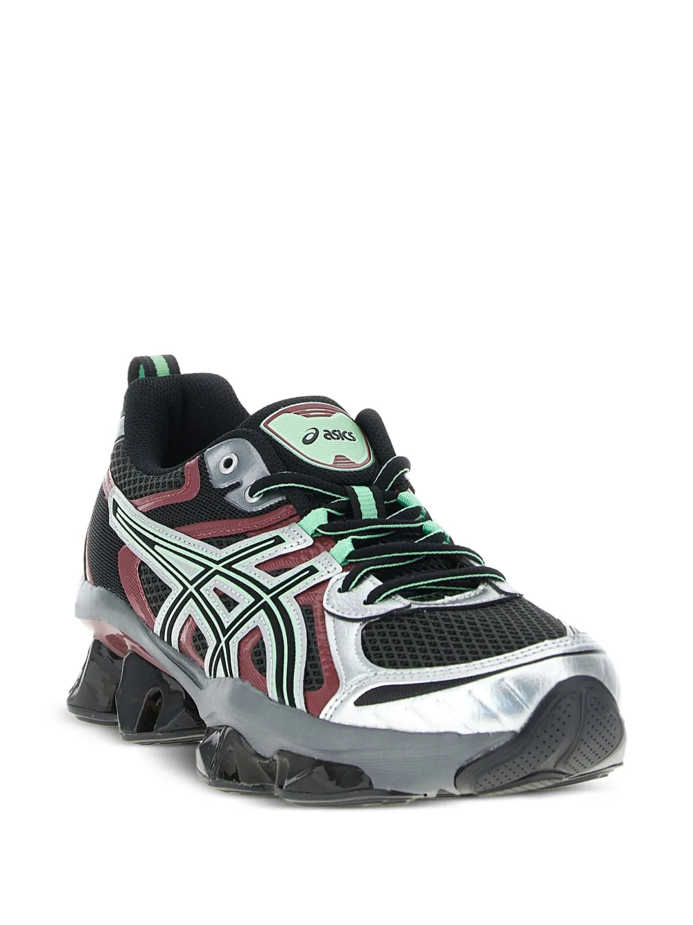 Black ASICS running shoe with white stripes, red panels, green laces, chunky outsole