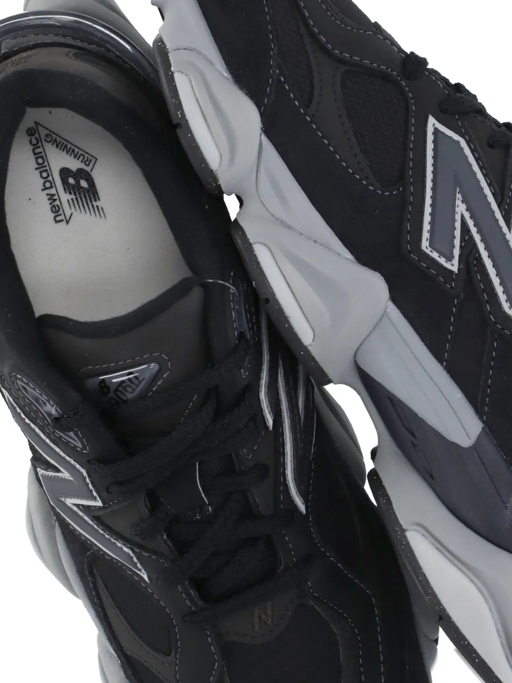 Close-up of black sneaker with white N logo detail and gray midsole