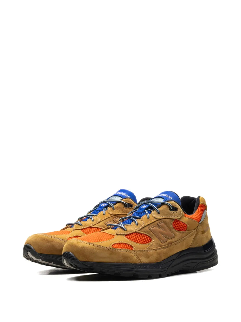 Tan suede New Balance 992 sneakers with blue laces, orange details, black sole