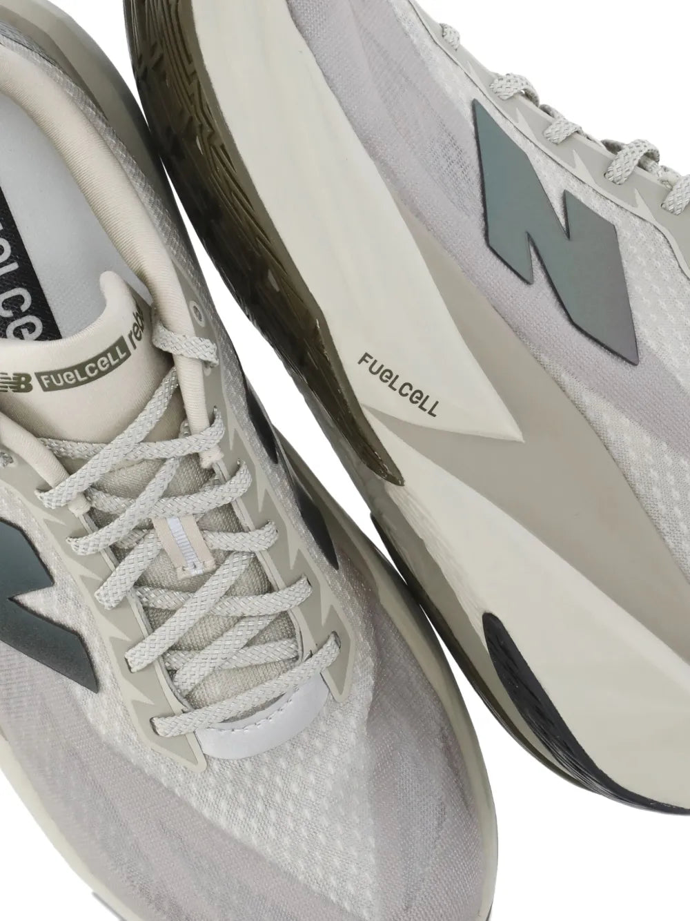 Close-up of beige mesh sneakers with white laces and FuelCell branding