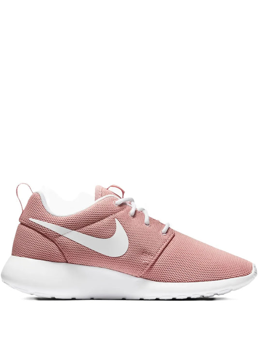 Nike Roshe Run pink knit running shoe with white swoosh, laces, and foam midsole