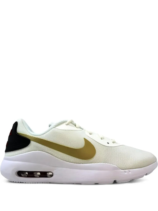 Nike Air Max Oketo beige sneakers with gold swoosh, black heel, visible air unit