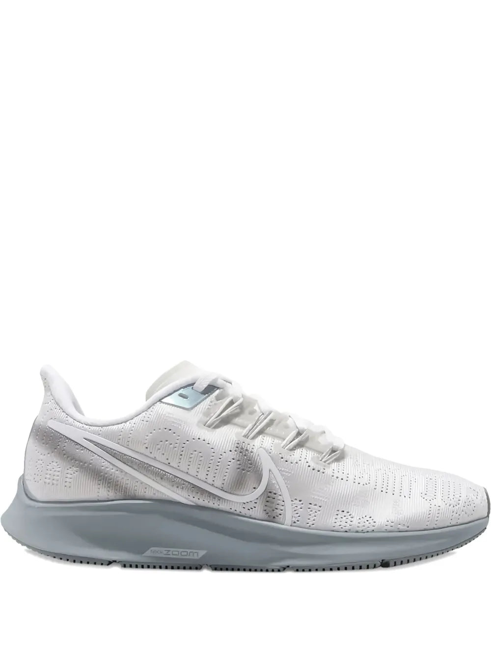 White Nike running sneaker with gray outsole and lace-up closure.
